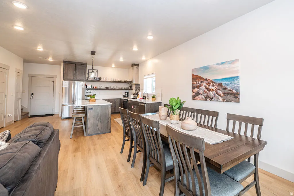 Dining space featuring light wood finished floors and recessed lighting