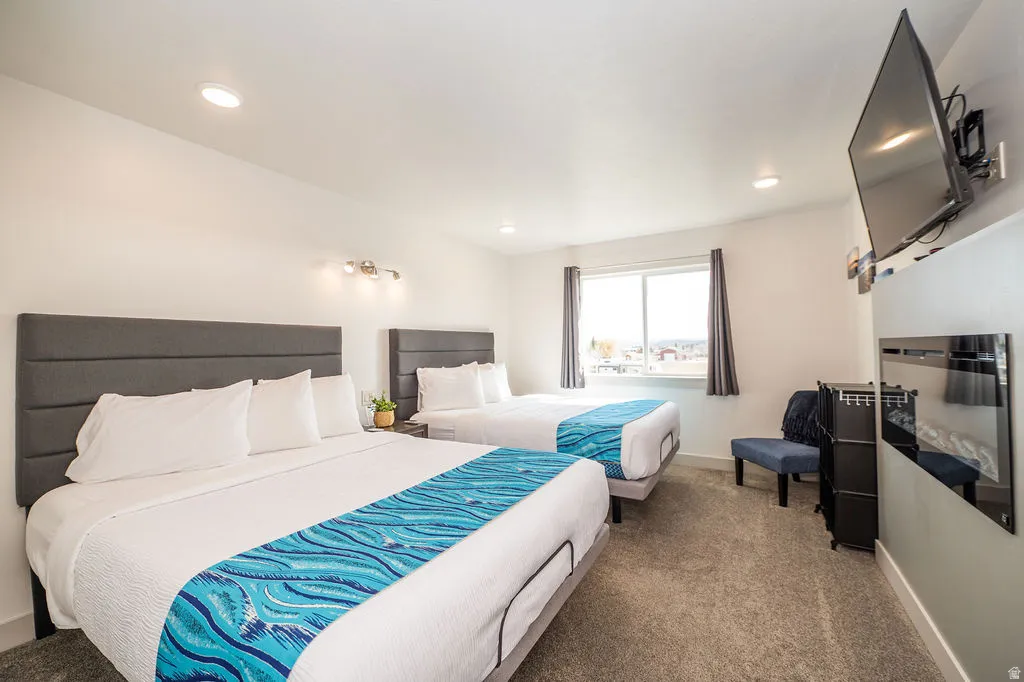 Carpeted bedroom featuring baseboards and recessed lighting