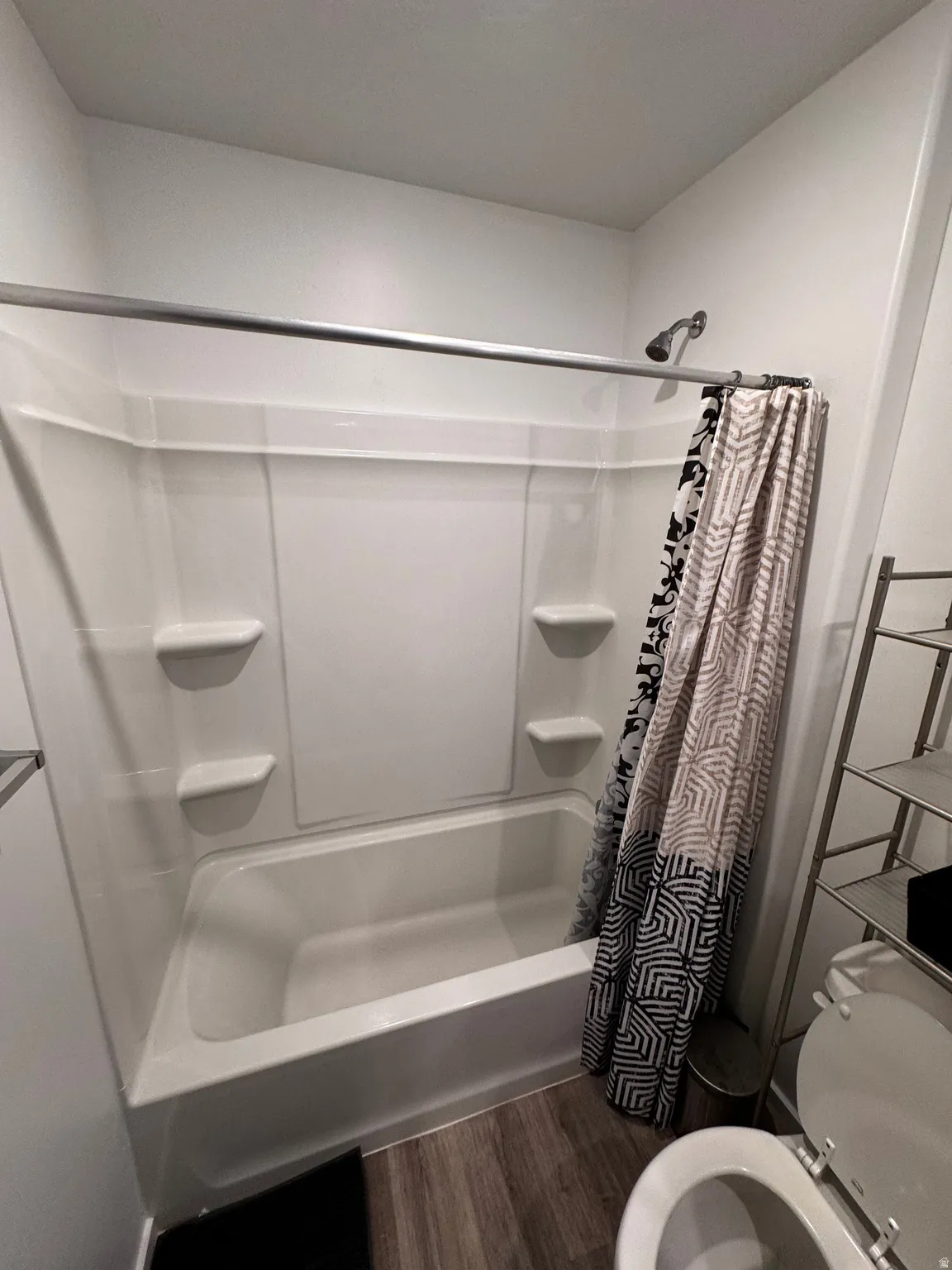 Bathroom featuring dark wood-style floors and toilet