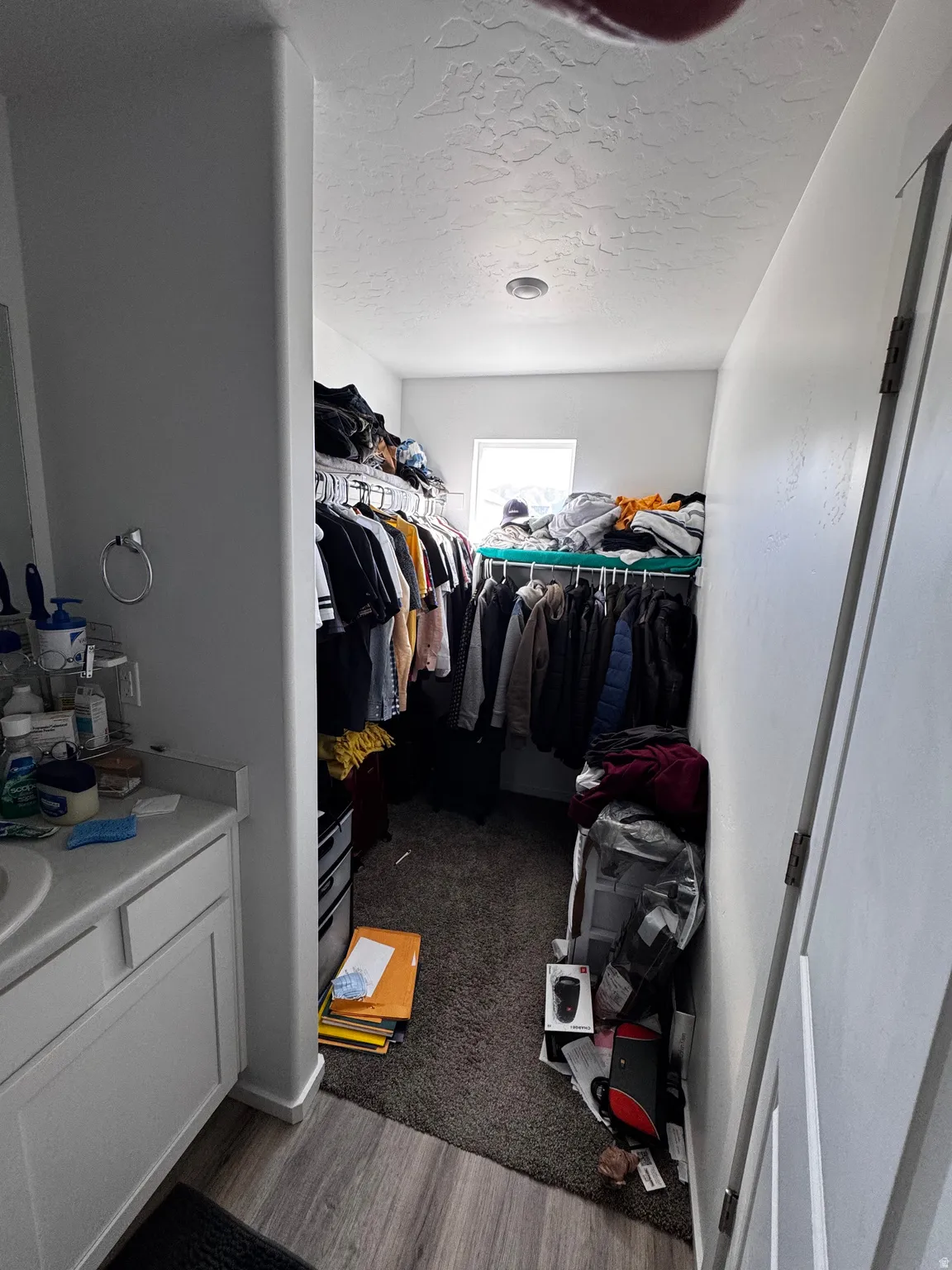 Walk in closet featuring dark wood-style floors