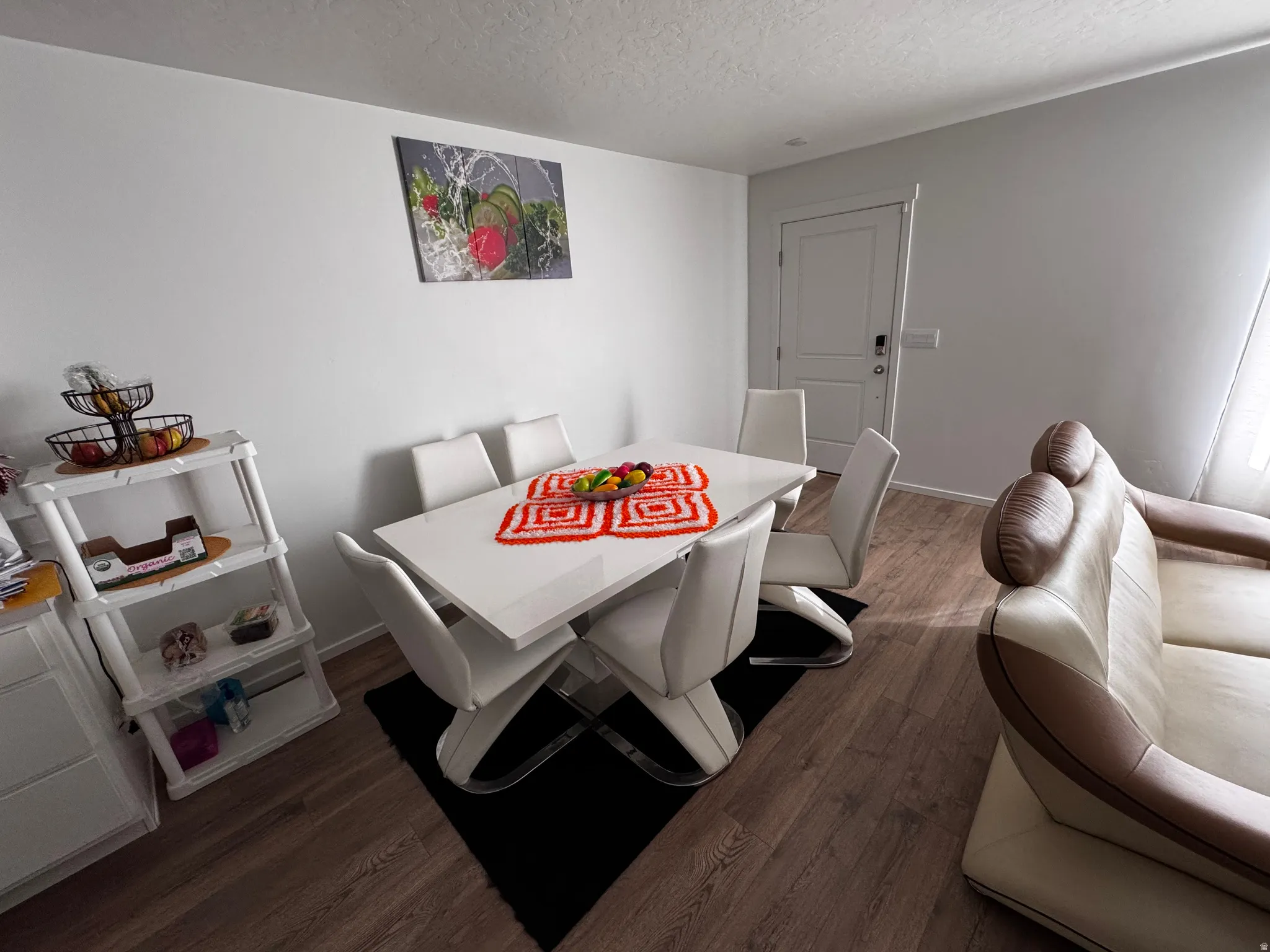 Dining room with wood finished floors and a textured ceiling