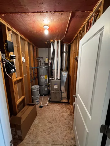 Utility room with water heater and heating unit