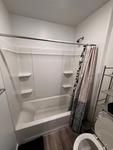 Bathroom featuring dark wood-style floors and toilet