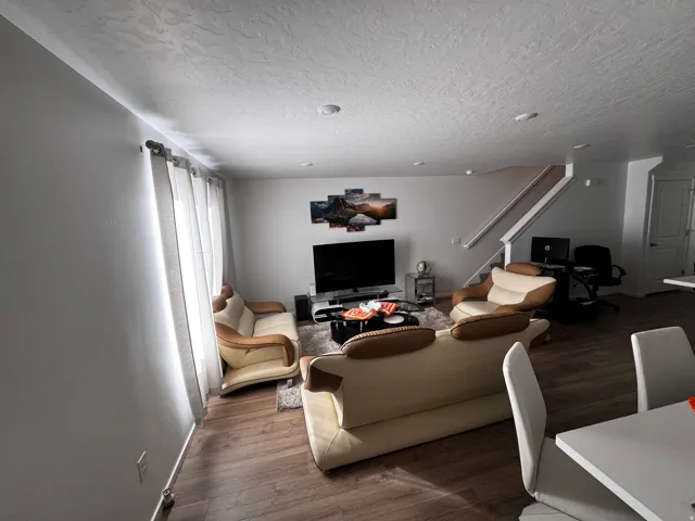 Living room featuring dark wood finished floors and a textured ceiling