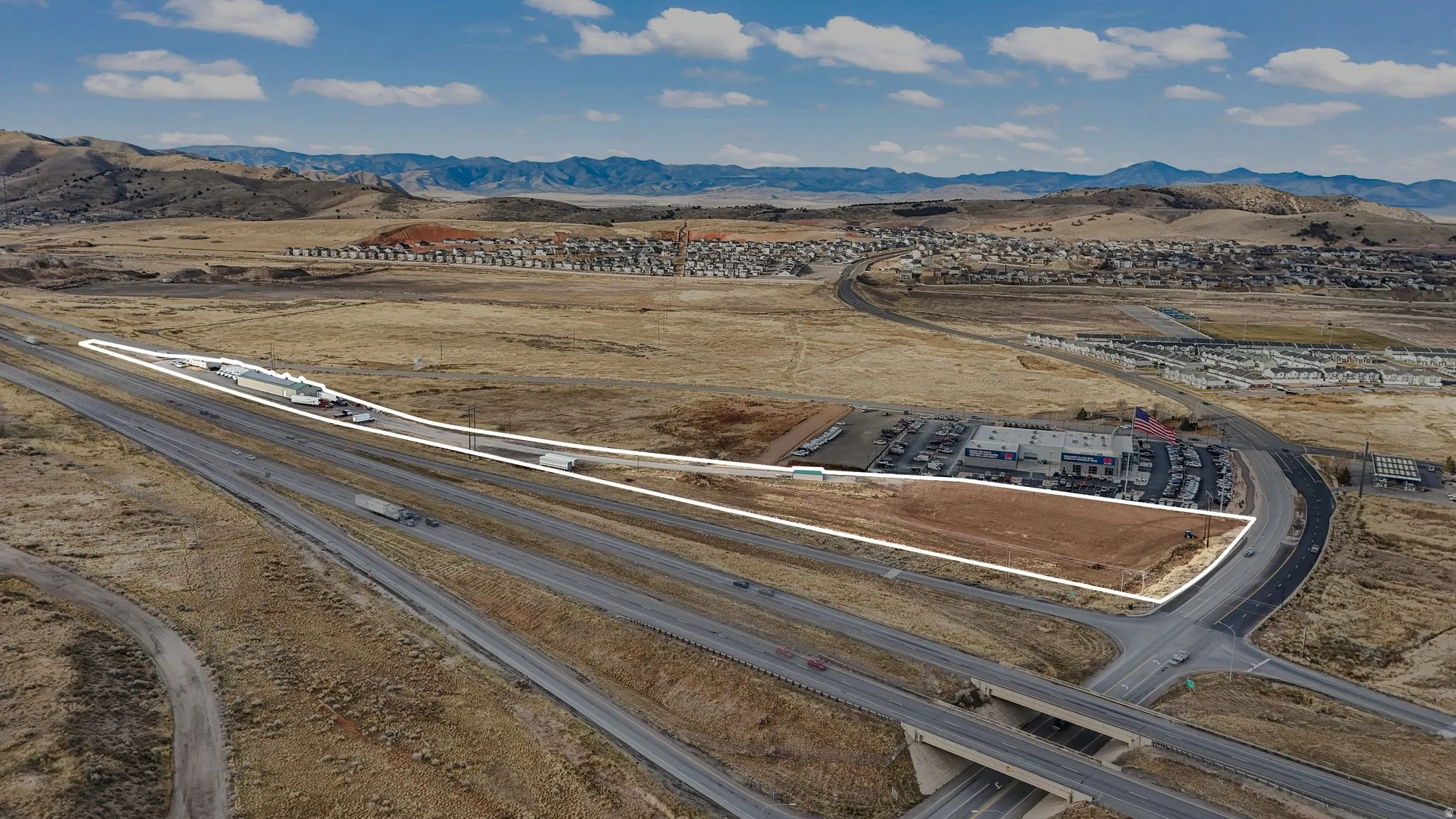 Bird's eye view of a mountain backdrop and a desert landscape
