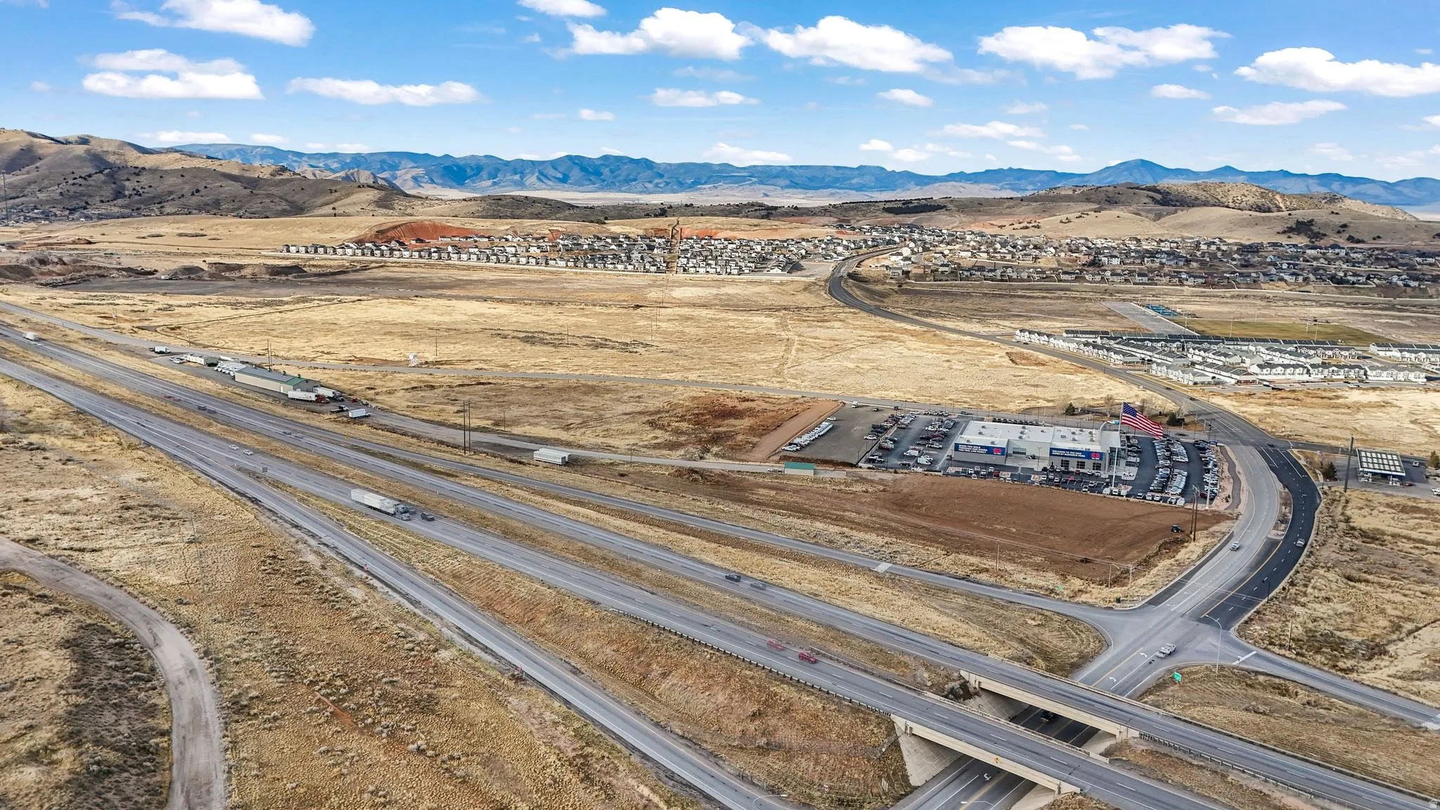 Drone / aerial view of a mountain backdrop and a desert landscape
