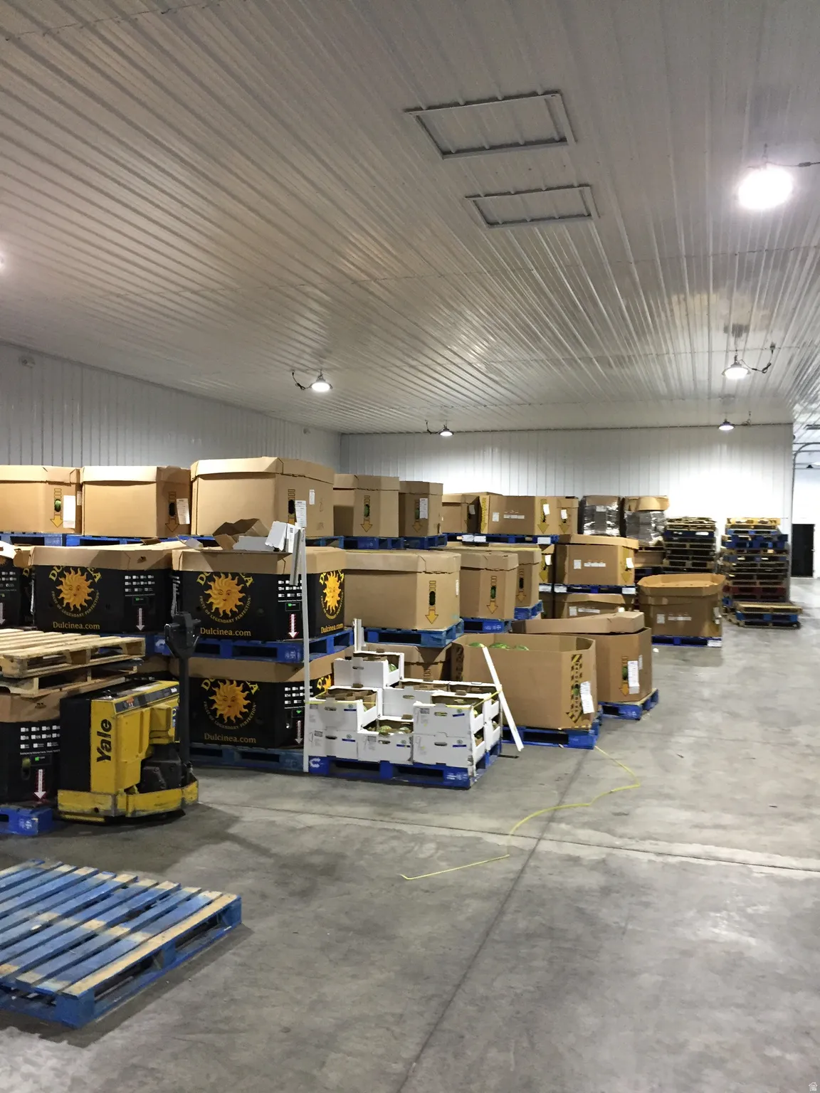 Garage with a workshop area and metal wall