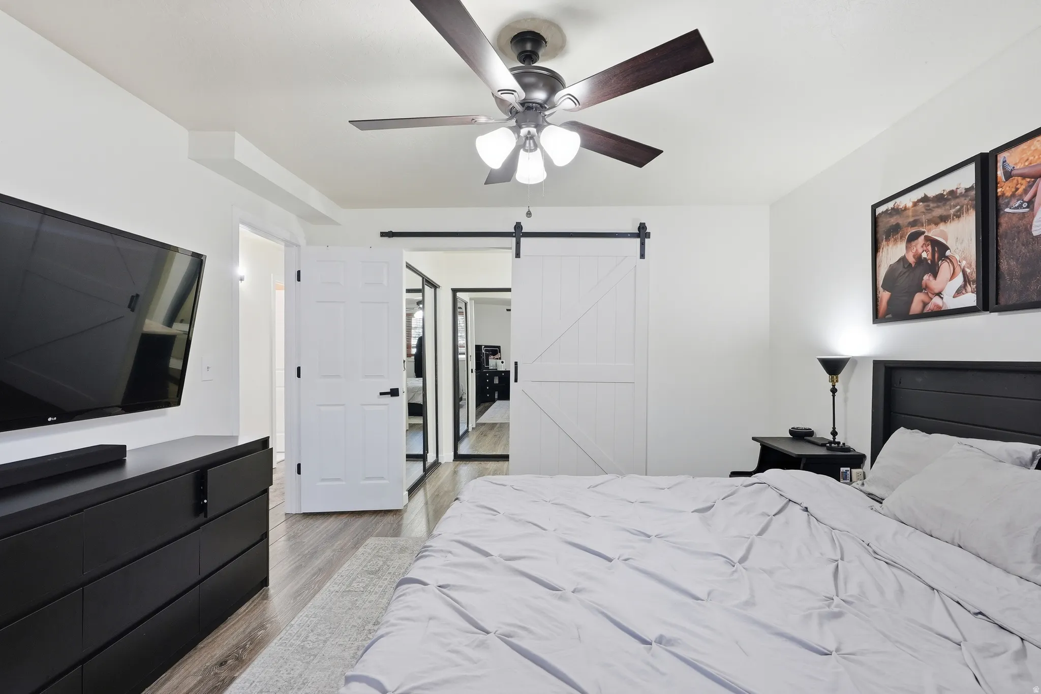 Primary bedroom featuring a barn door.