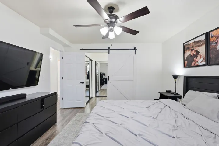 Primary bedroom featuring a barn door.