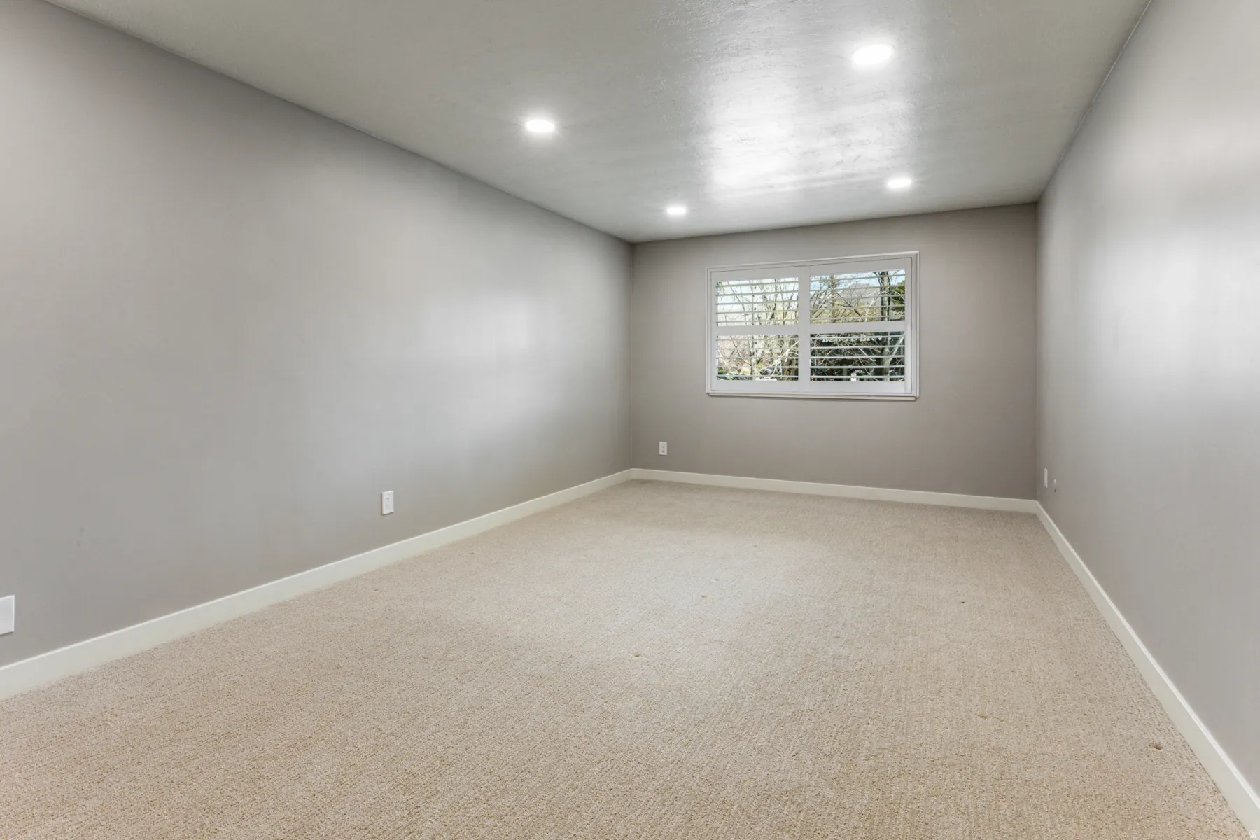 Spare room featuring light carpet and recessed lighting