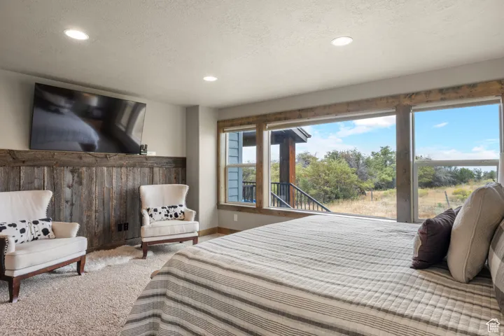 Carpeted bedroom with recessed lighting and a textured ceiling