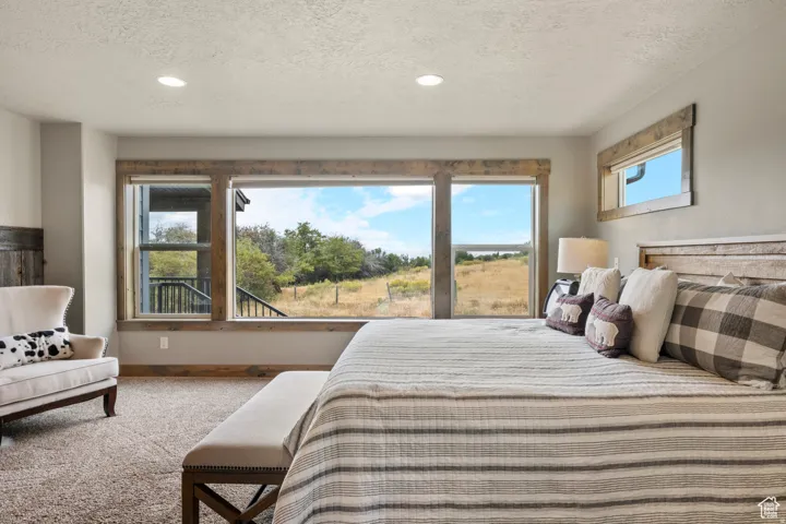 Carpeted bedroom featuring recessed lighting and a textured ceiling