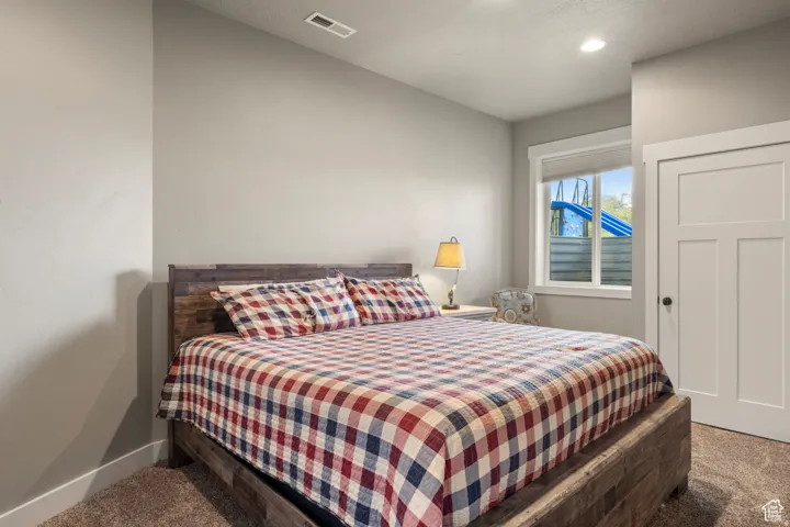 Carpeted bedroom featuring baseboards