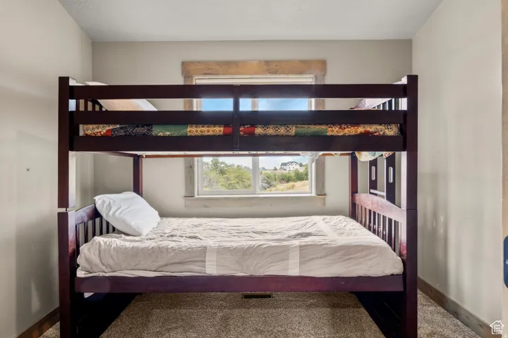 Carpeted bedroom with baseboards