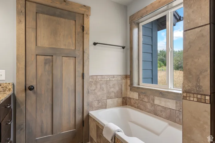 Full bath with a bath and vanity