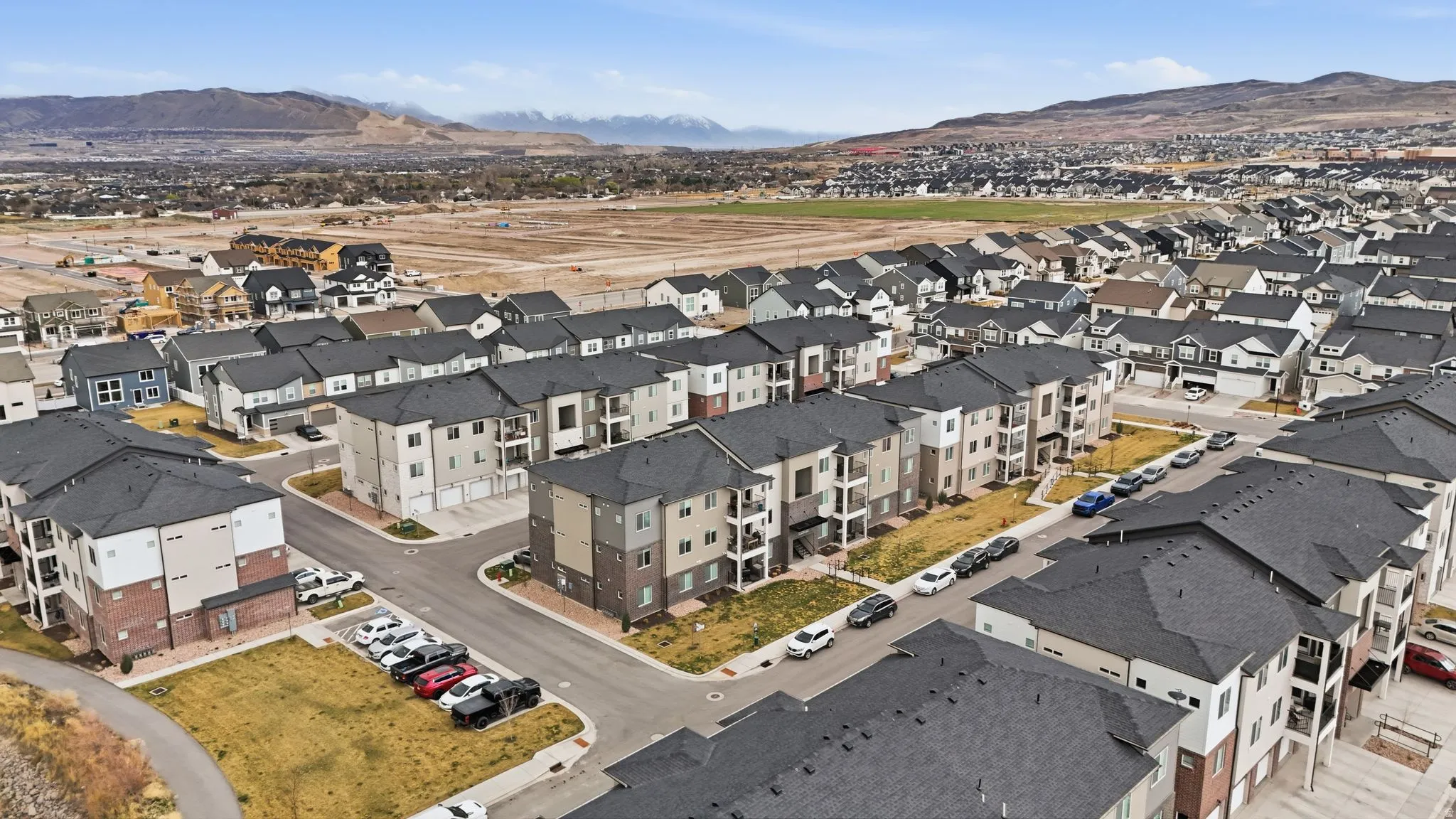 Aerial view of property's location featuring a mountain backdrop and nearby suburban area