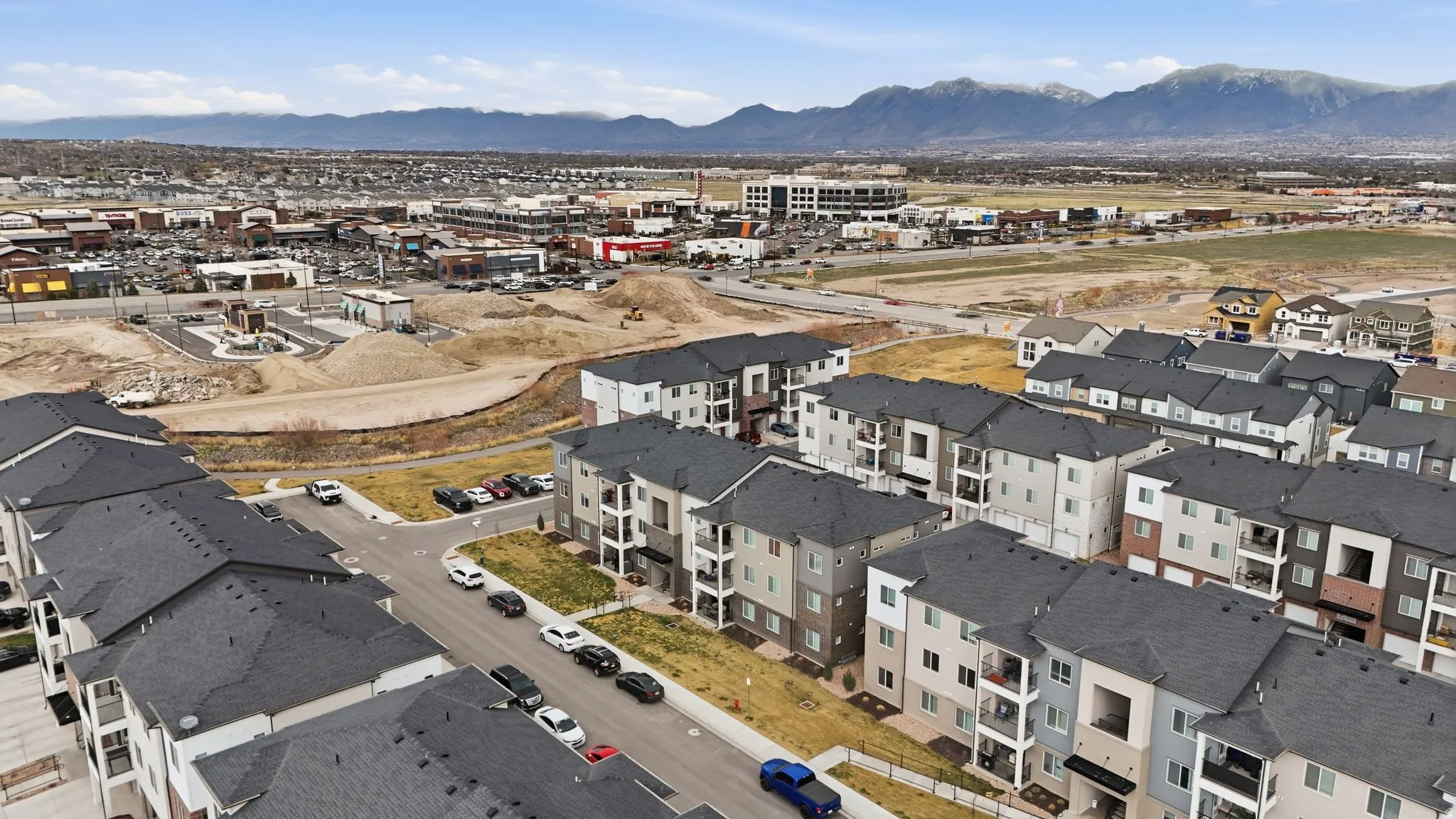 Aerial overview of property's location with mountains and nearby suburban area