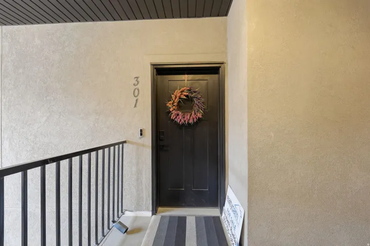 Property entrance featuring stucco siding