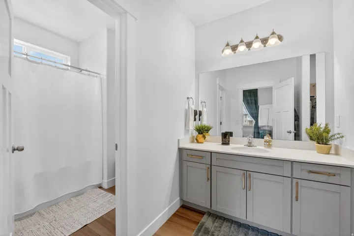 Bathroom featuring vanity, a shower with shower curtain, and light wood finished floors