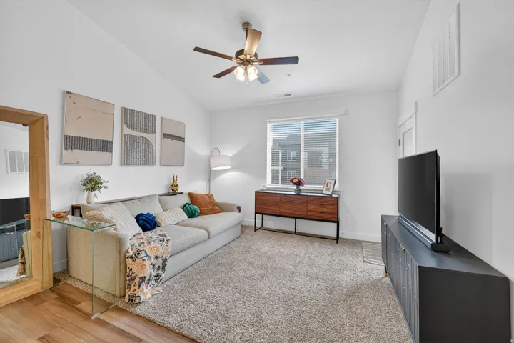 Living room with ceiling fan and vaulted ceiling