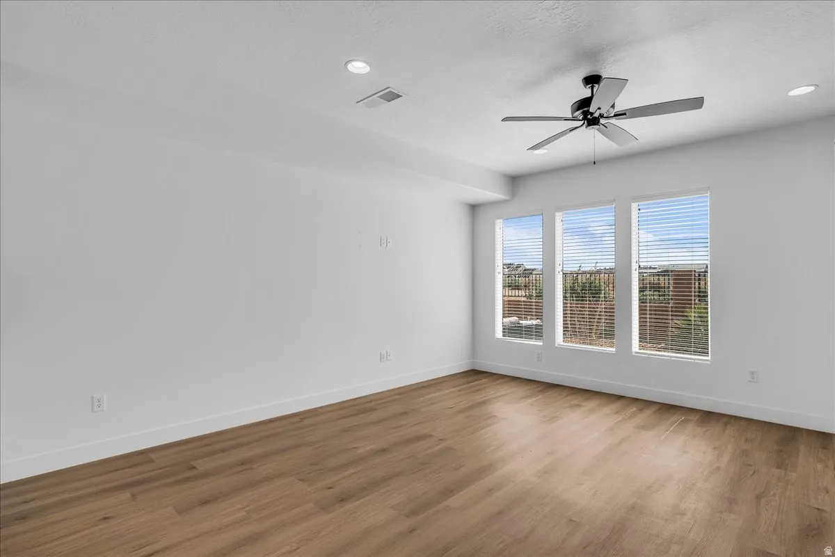 Spare room featuring a ceiling fan, wood finished floors, and recessed lighting