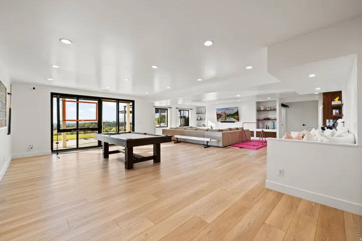 Rec room with light wood-style floors, billiards table, and recessed lighting