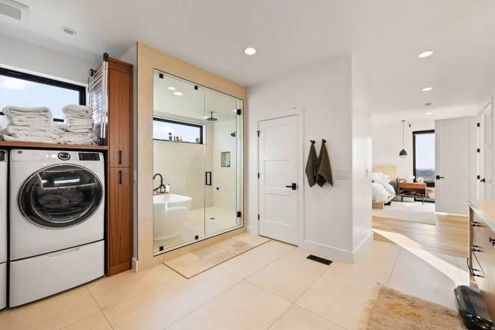 Bathroom with a stall shower, light tile patterned floors, ensuite bath, a soaking tub, and recessed lighting