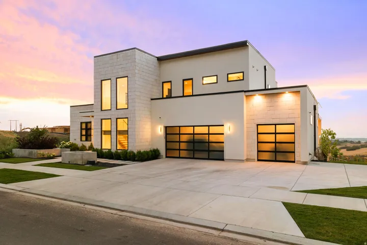 Contemporary home with driveway, stucco siding, and a garage