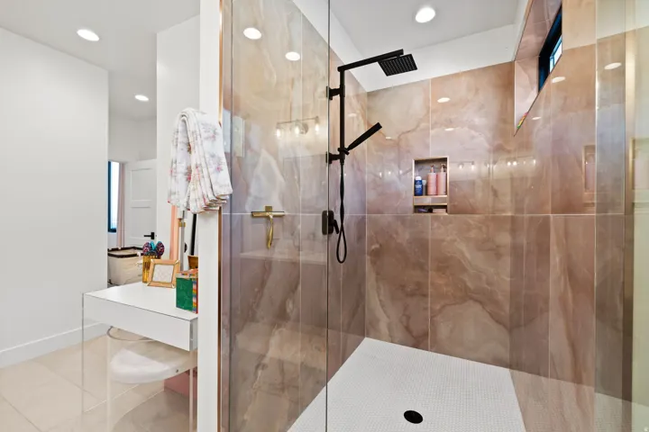 Bathroom with a stall shower, light tile patterned floors, vanity, and recessed lighting