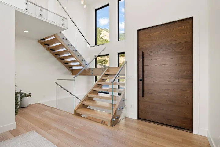 Foyer entrance with a high ceiling and light wood-style flooring