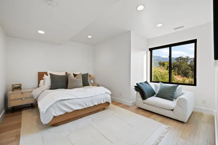 Bedroom with light wood-type flooring, recessed lighting, and a mountain view