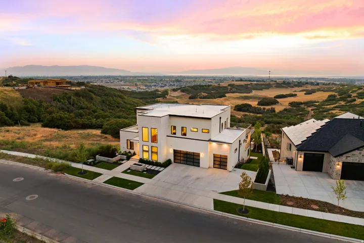 Contemporary house featuring stucco siding, driveway, a mountain view, and a garage