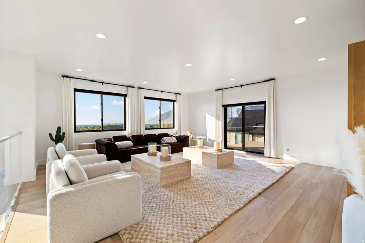 Living area featuring light wood-style flooring and recessed lighting