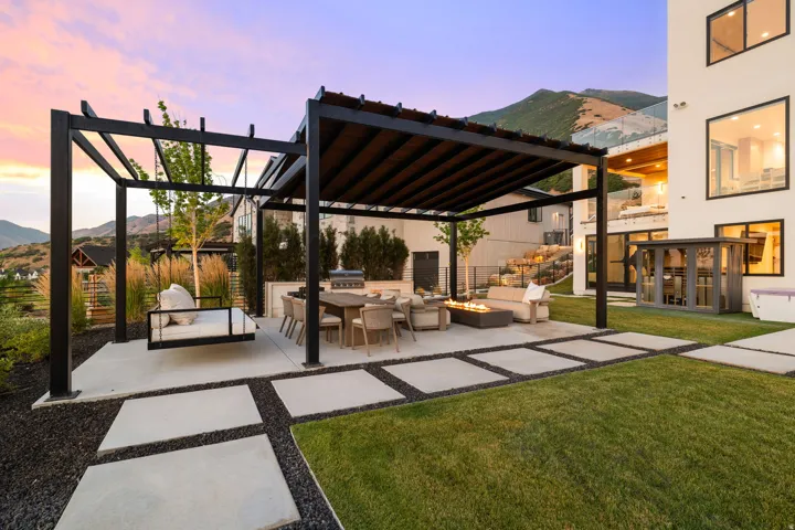 View of patio featuring a pergola, a mountain view, an outdoor fire pit, and an outdoor kitchen with living area
