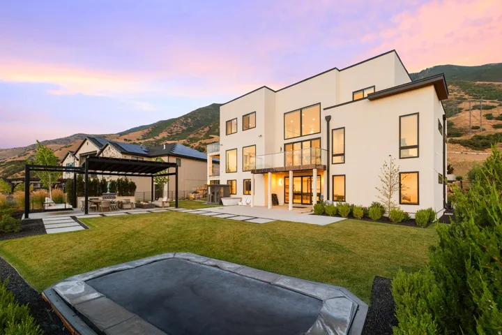 Back of property featuring a patio area, a mountain view, and stucco siding