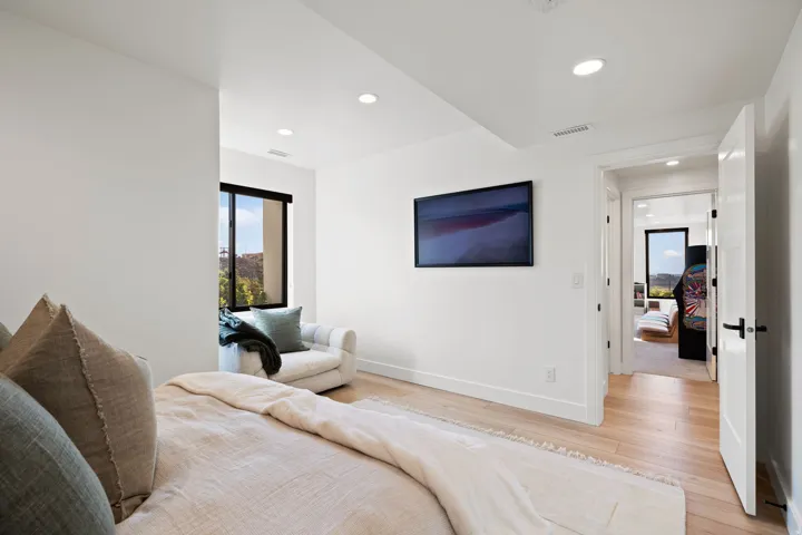 Bedroom with light wood finished floors and recessed lighting