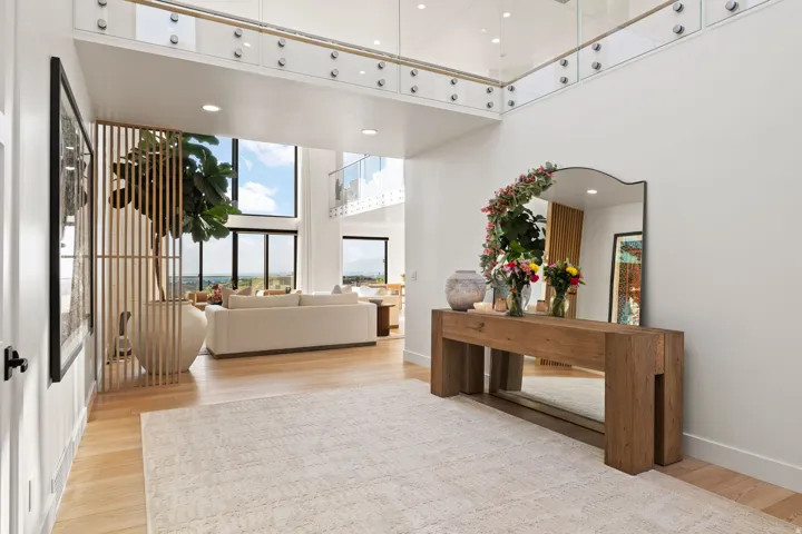Foyer with a high ceiling, recessed lighting, and light wood-type flooring