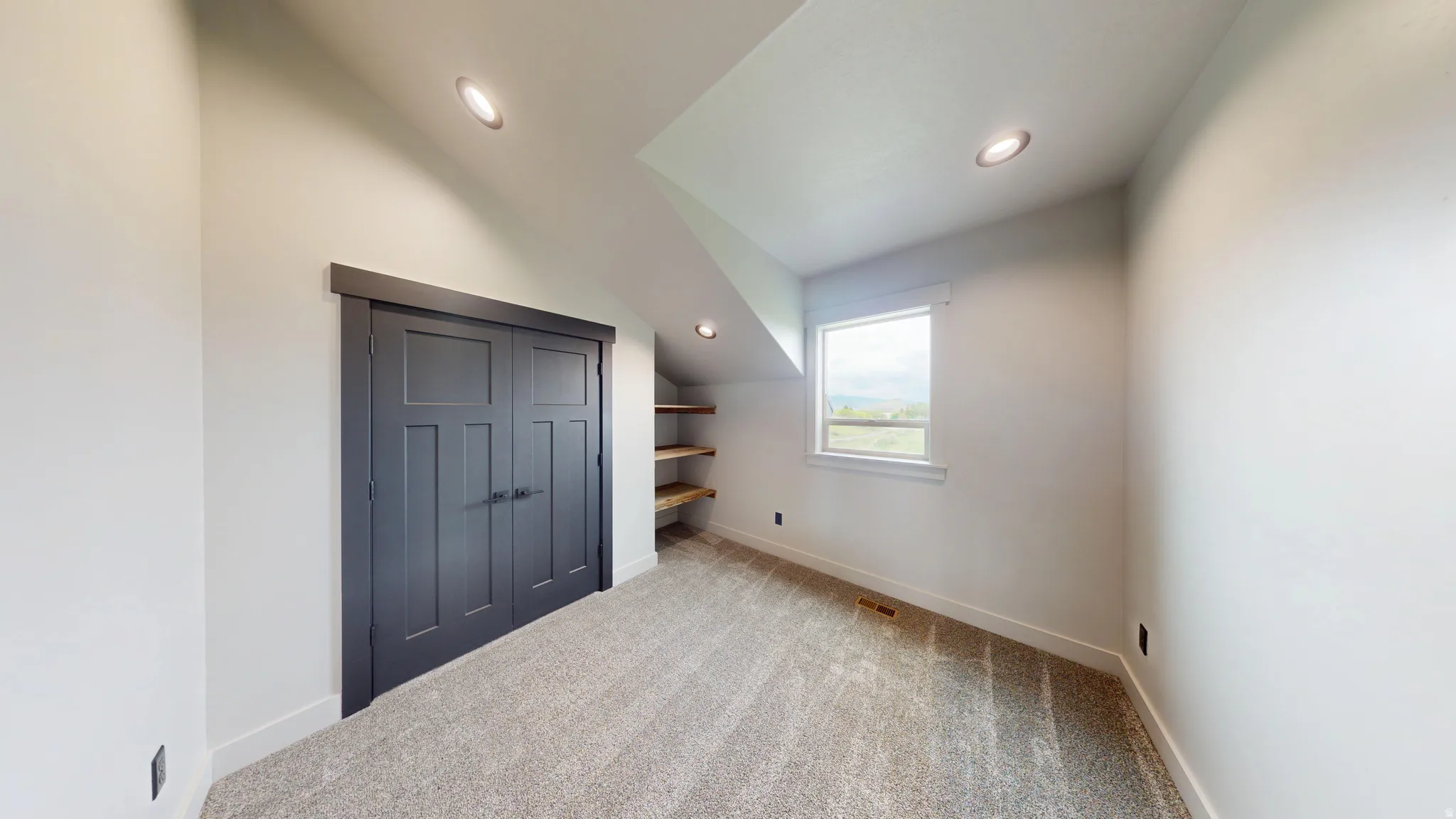 Additional living space with light carpet, lofted ceiling, and recessed lighting
