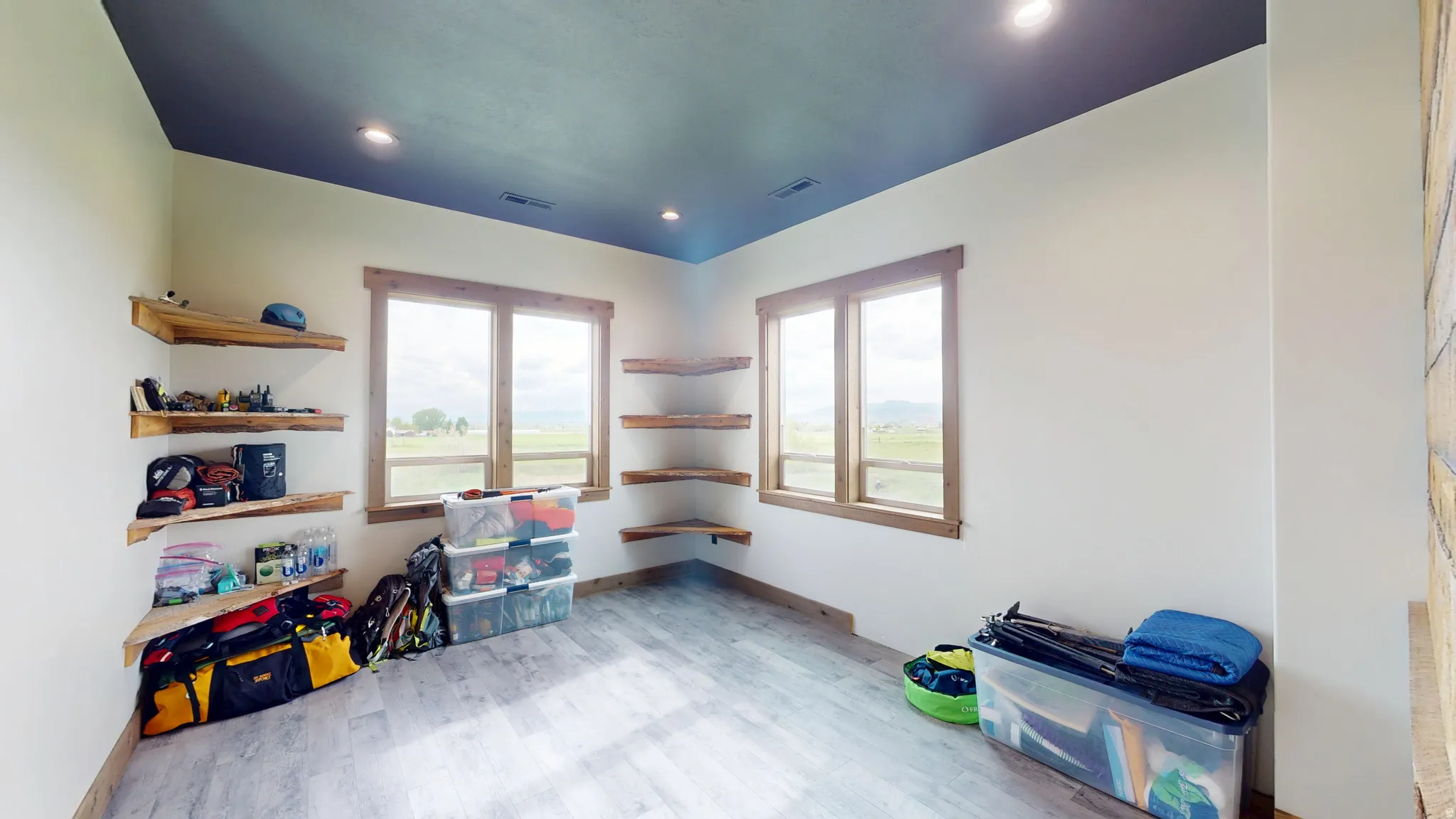 Rec room with light wood-type flooring and recessed lighting