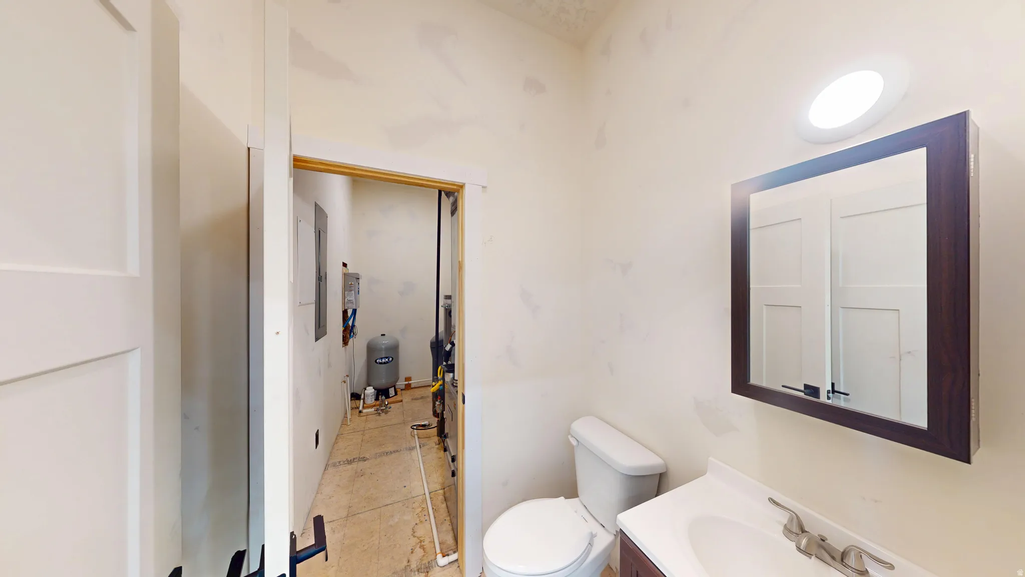 Half bath featuring toilet and vanity