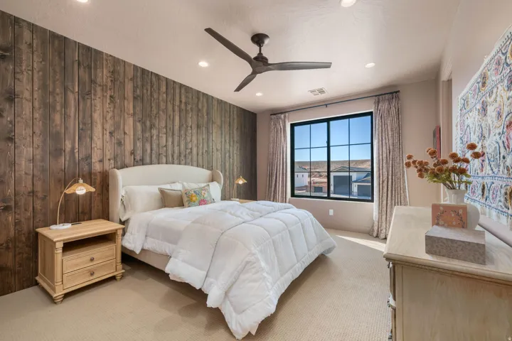 Bedroom with light carpet, a ceiling fan, recessed lighting, and wood walls