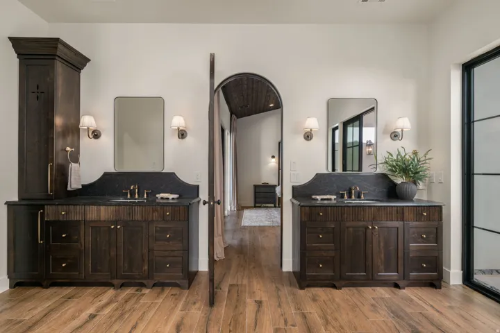 Full bath featuring two vanities and light wood-style flooring