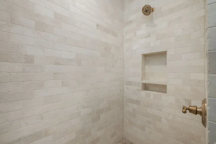 Bathroom featuring tiled shower