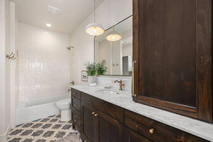 Bathroom with vanity, shower / bathtub combination, and recessed lighting