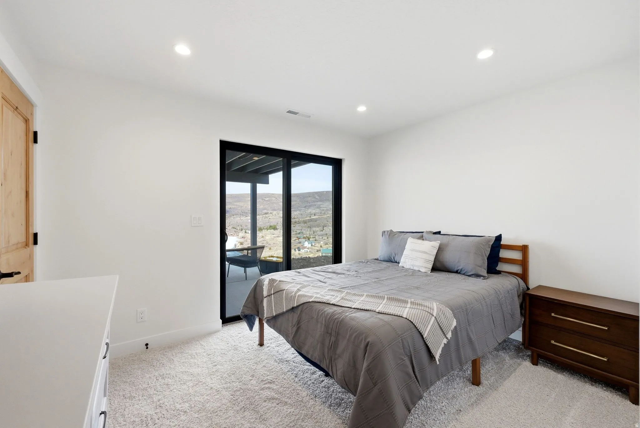 Bedroom featuring access to outside, light colored carpet, and recessed lighting