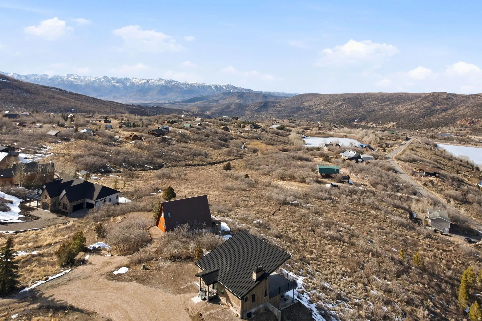 Aerial view of residential area with mountains and ski runs