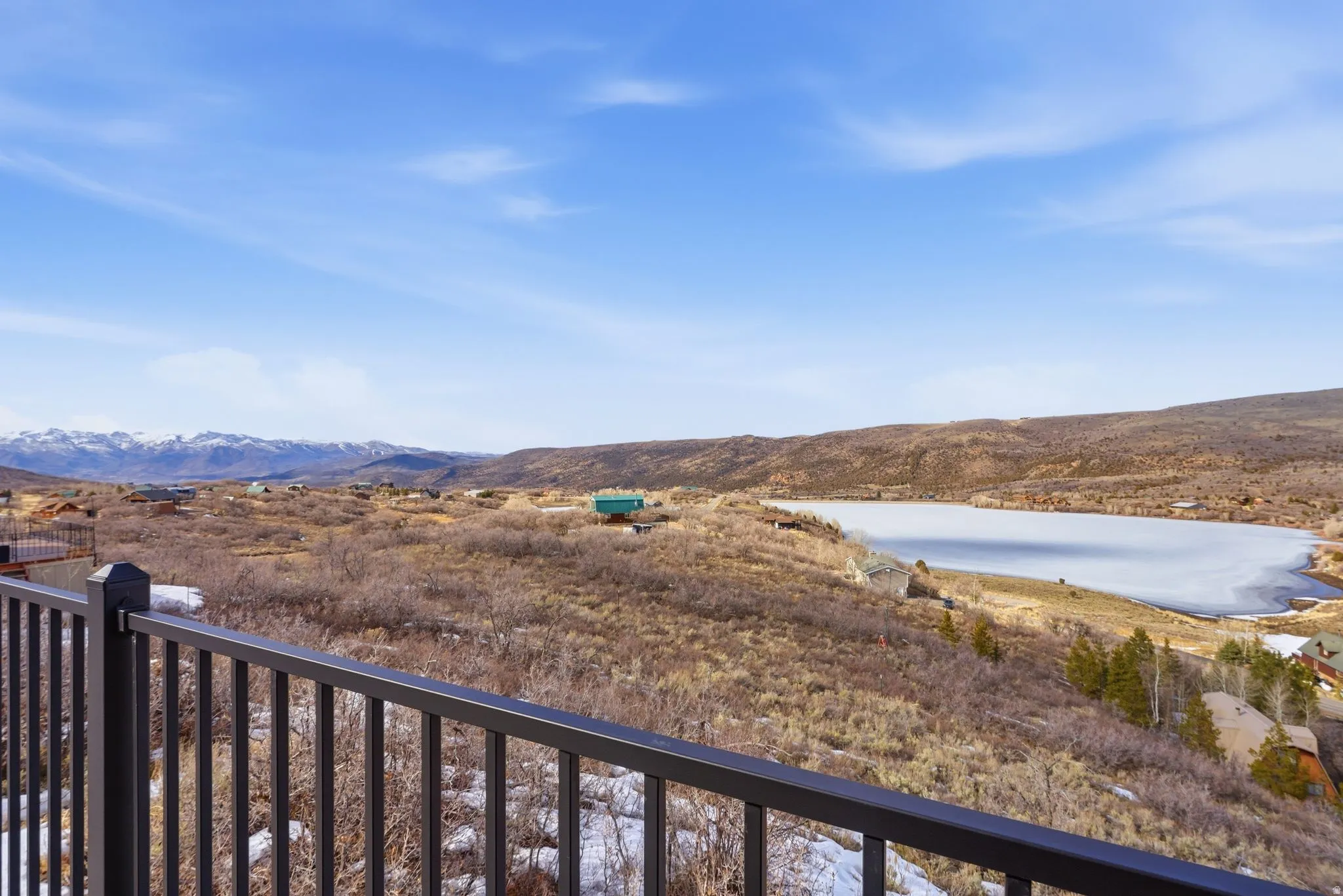 View of Witt's Lake with mountains with views of Mayflower and Deer Valley Ski Resort runs