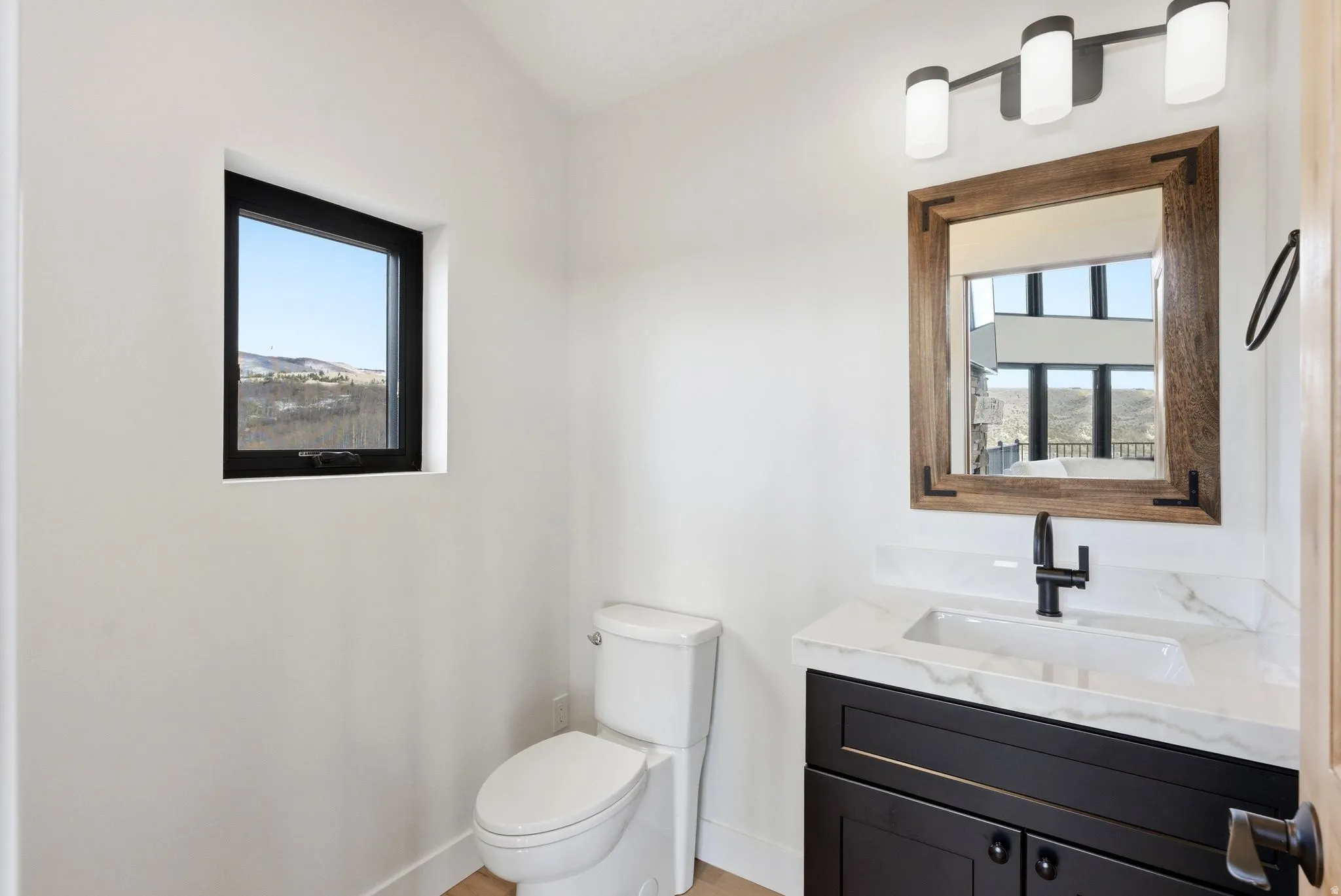 Bathroom featuring vanity and lofted ceiling