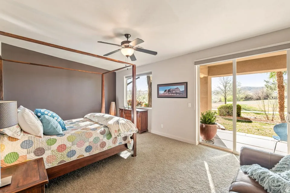 Bedroom with carpet, access to outside, a ceiling fan, and a mountain view