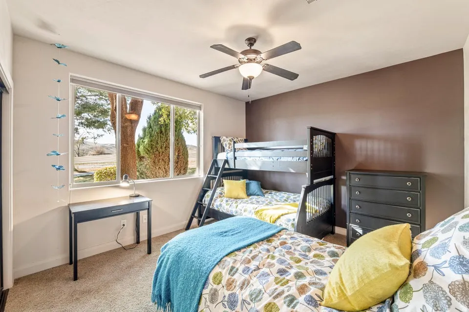 Bedroom featuring carpet and a ceiling fan